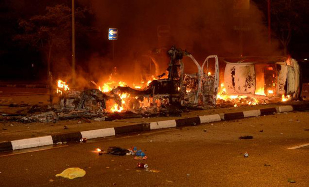 In this December 8, 2013 photo, police vehicles go up in flames after a riot broke out in Singapore's Little India. Singapore on Wednesday extended by six months the ban on alcohol consumption in public during weekends and holidays at Little India In this December 8, 2013 photo, police vehicles go up in flames after a riot broke out in Singapore's Little India. Singapore on Wednesday extended by six months the ban on alcohol consumption in public during weekends and holidays at Little India